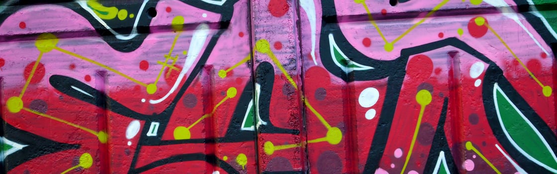 Colorful background of graffiti painting artwork with bright aerosol outlines on wall. Old school street art piece made with aerosol spray paint cans. Contemporary youth culture photo