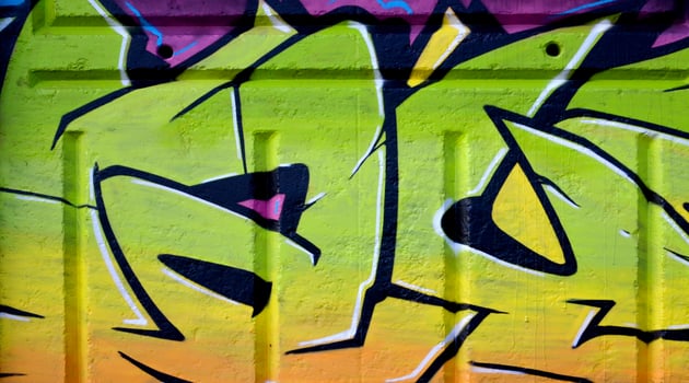 Colorful background of graffiti painting artwork with bright aerosol outlines on wall. Old school street art piece made with aerosol spray paint cans. Contemporary youth culture photo