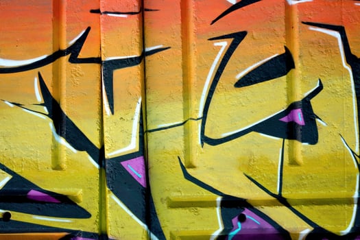 Colorful background of graffiti painting artwork with bright aerosol outlines on wall. Old school street art piece made with aerosol spray paint cans. Contemporary youth culture photo