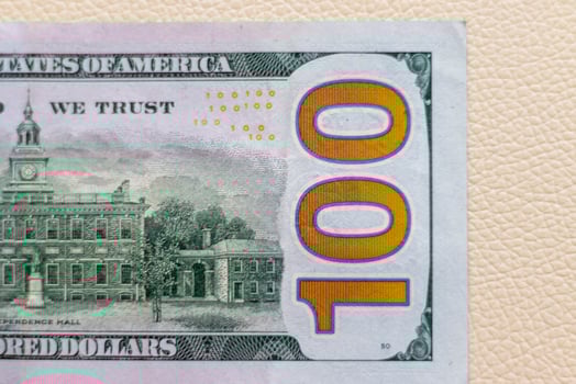 Close up shot of the US dollars note bill on the white leather background. Finance photo