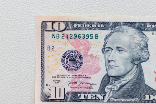 Close up shot of the US dollars note bill on the white leather background. Finance photo