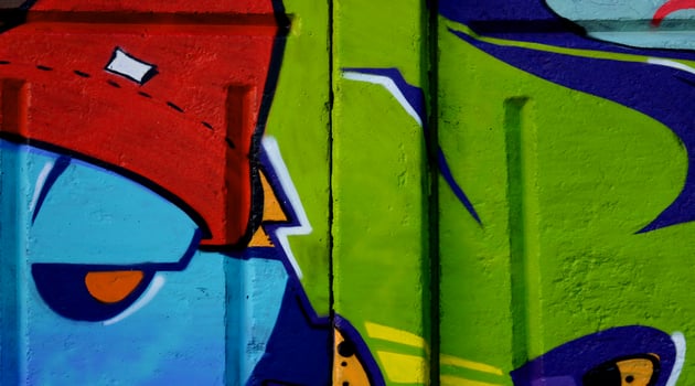 Colorful background of graffiti painting artwork with bright aerosol outlines on wall. Old school street art piece made with aerosol spray paint cans. Contemporary youth culture photo