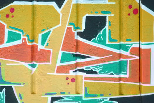 Colorful background of graffiti painting artwork with bright aerosol outlines on wall. Old school street art piece made with aerosol spray paint cans. Contemporary youth culture photo