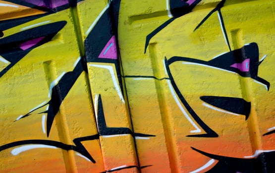 Colorful background of graffiti painting artwork with bright aerosol outlines on wall. Old school street art piece made with aerosol spray paint cans. Contemporary youth culture photo