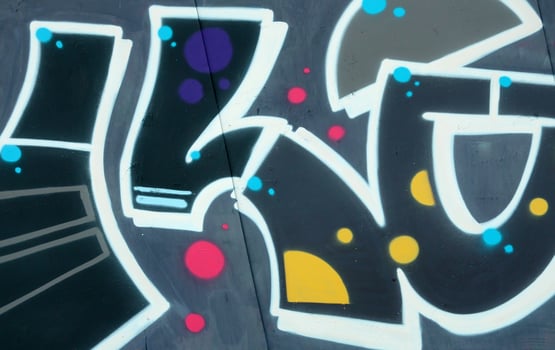 Colorful background of graffiti painting artwork with bright aerosol outlines on wall. Old school street art piece made with aerosol spray paint cans. Contemporary youth culture photo