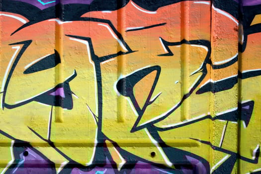 Colorful background of graffiti painting artwork with bright aerosol outlines on wall. Old school street art piece made with aerosol spray paint cans. Contemporary youth culture photo