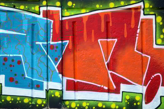 Colorful background of graffiti painting artwork with bright aerosol outlines on wall. Old school street art piece made with aerosol spray paint cans. Contemporary youth culture photo