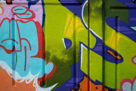 Colorful background of graffiti painting artwork with bright aerosol outlines on wall. Old school street art piece made with aerosol spray paint cans. Contemporary youth culture photo