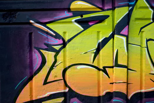 Colorful background of graffiti painting artwork with bright aerosol outlines on wall. Old school street art piece made with aerosol spray paint cans. Contemporary youth culture photo