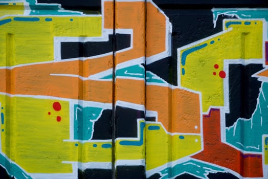 Colorful background of graffiti painting artwork with bright aerosol outlines on wall. Old school street art piece made with aerosol spray paint cans. Contemporary youth culture photo