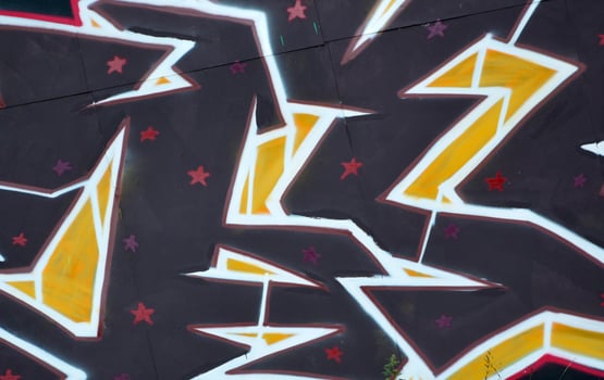 Colorful background of graffiti painting artwork with bright aerosol outlines on wall. Old school street art piece made with aerosol spray paint cans. Contemporary youth culture photo
