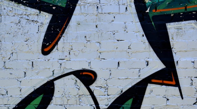 Colorful background of graffiti painting artwork with bright aerosol outlines on wall. Old school street art piece made with aerosol spray paint cans. Contemporary youth culture photo