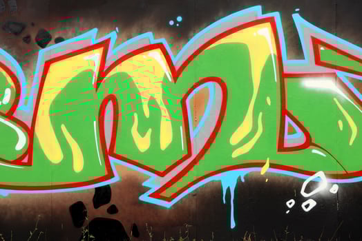Colorful background of graffiti painting artwork with bright aerosol outlines on wall. Old school street art piece made with aerosol spray paint cans. Contemporary youth culture photo