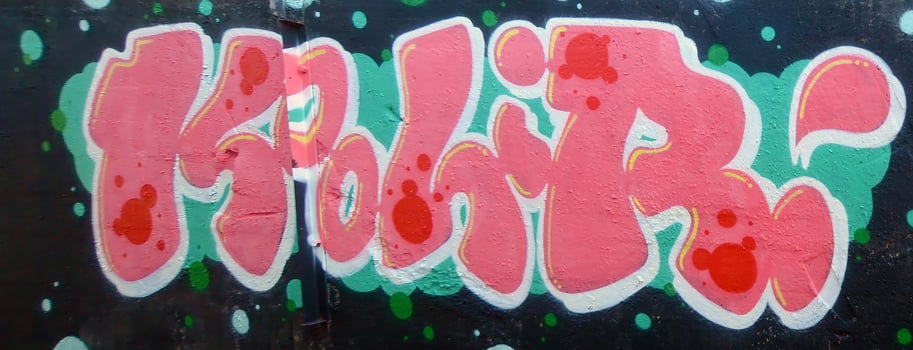 Colorful background of graffiti painting artwork with bright aerosol outlines on wall. Old school street art piece made with aerosol spray paint cans. Contemporary youth culture photo