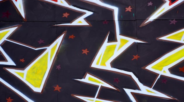 Colorful background of graffiti painting artwork with bright aerosol outlines on wall. Old school street art piece made with aerosol spray paint cans. Contemporary youth culture photo