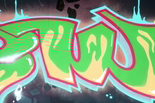 Colorful background of graffiti painting artwork with bright aerosol outlines on wall. Old school street art piece made with aerosol spray paint cans. Contemporary youth culture photo