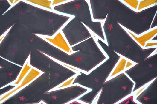 Colorful background of graffiti painting artwork with bright aerosol outlines on wall. Old school street art piece made with aerosol spray paint cans. Contemporary youth culture photo