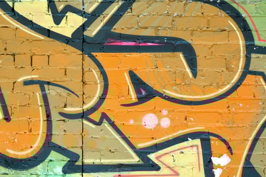 Colorful background of graffiti painting artwork with bright aerosol outlines on wall. Old school street art piece made with aerosol spray paint cans. Contemporary youth culture photo