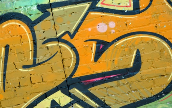 Colorful background of graffiti painting artwork with bright aerosol outlines on wall. Old school street art piece made with aerosol spray paint cans. Contemporary youth culture photo