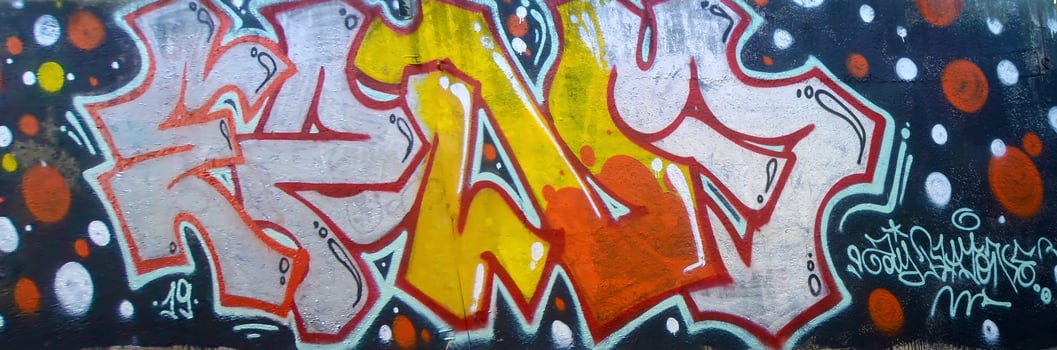 Colorful background of graffiti painting artwork with bright aerosol outlines on wall. Old school street art piece made with aerosol spray paint cans. Contemporary youth culture photo
