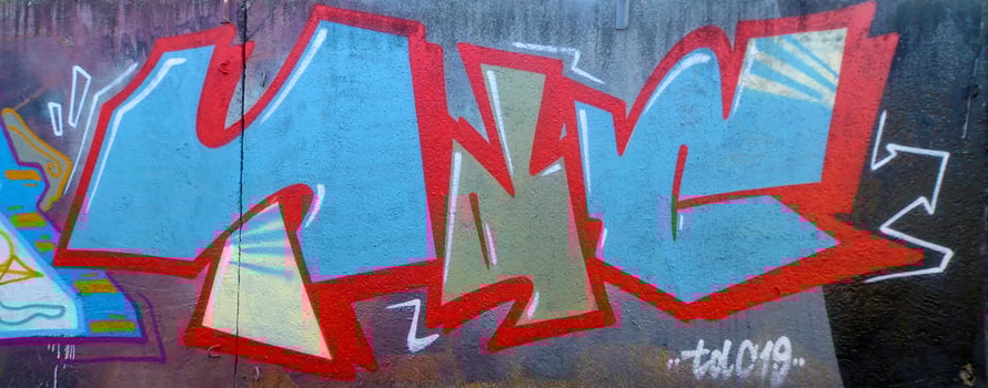 Colorful background of graffiti painting artwork with bright aerosol outlines on wall. Old school street art piece made with aerosol spray paint cans. Contemporary youth culture photo