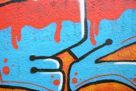 Colorful background of graffiti painting artwork with bright aerosol outlines on wall. Old school street art piece made with aerosol spray paint cans. Contemporary youth culture photo