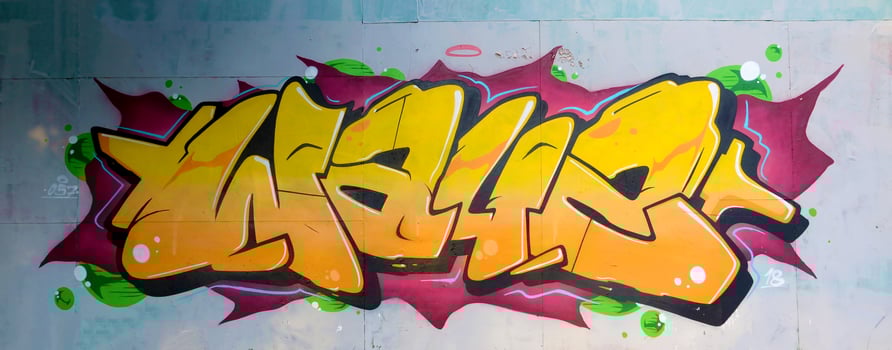 Colorful background of graffiti painting artwork with bright aerosol outlines on wall. Old school street art piece made with aerosol spray paint cans. Contemporary youth culture photo