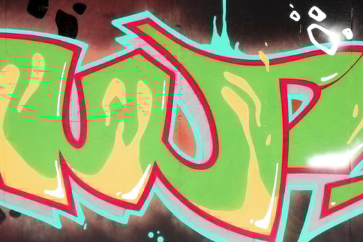 Colorful background of graffiti painting artwork with bright aerosol outlines on wall. Old school street art piece made with aerosol spray paint cans. Contemporary youth culture photo