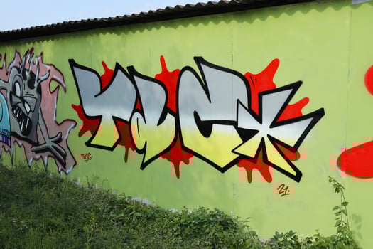 Colorful background of graffiti painting artwork with bright aerosol outlines on wall. Old school street art piece made with aerosol spray paint cans. Contemporary youth culture photo