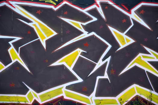 Colorful background of graffiti painting artwork with bright aerosol outlines on wall. Old school street art piece made with aerosol spray paint cans. Contemporary youth culture photo