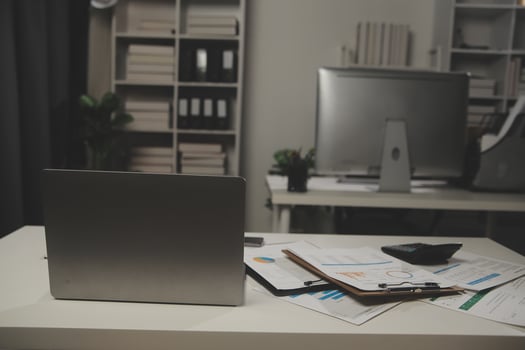 Laptop computer with opened lid on table in meeting room of office workspace. photo