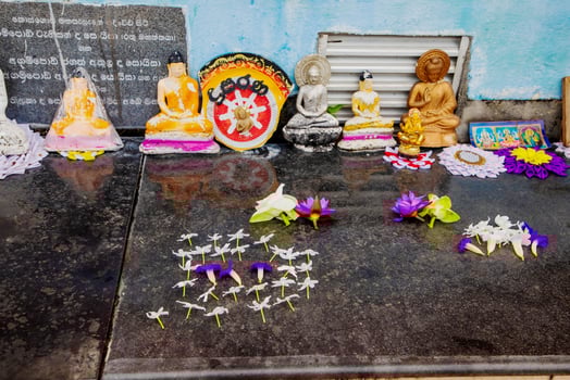 Flowers and fruits collected in baskets for offering to Buddha statue photo