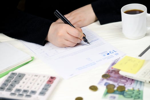 KYIV, UKRAINE - OCTOBER 31, 2023 Accountant fill french tax form 2042 NR departure abroad or return to France in end of tax period. Taxation and paperwork routine photo