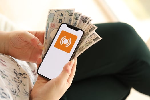 KYIV, UKRAINE - APRIL 1, 2024 WeiTao icon on smartphone screen and money in female hand photo
