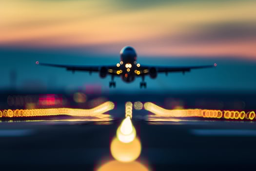 Twilight landing - airplane approaching on runway photo