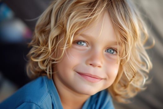Cheerful young child with curly hair smiling photo