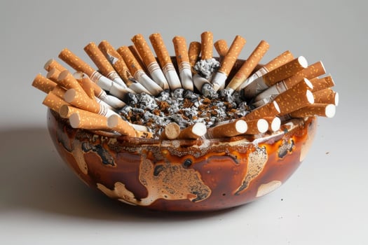Overflowing ashtray with extinguished cigarettes photo