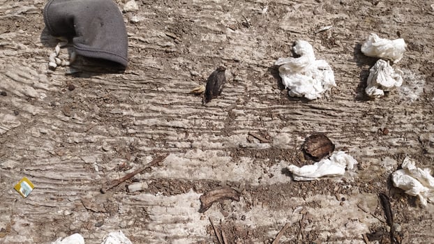 The surface of the ground is full of tissue waste scattered everywhere accompanied by dust stuck to the floor. very suitable for the background of a cleanliness campaign photo