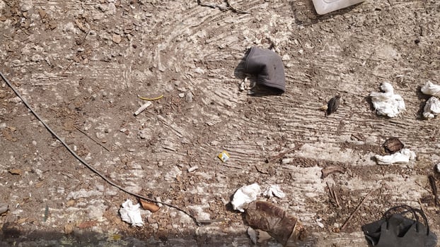 The surface of the ground is full of tissue waste scattered everywhere accompanied by dust stuck to the floor. very suitable for the background of a cleanliness campaign photo