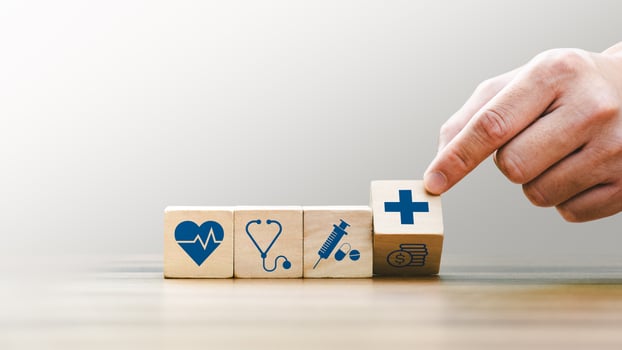 Health insurance concept, Hand Arranging Wooden Blocks with Medical Icons Including Heartbeat, Stethoscope, Syringe, and Healthcare Cross Symbol, Future Healthcare Technology photo