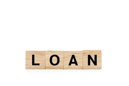 LOAN word wooden blocks isolated on white background. copy space and clipping path. Real estate market and finance concept. photo