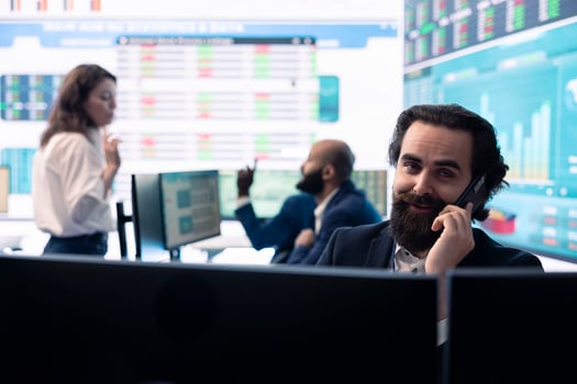 Chairman of the advisory board transmits potential company expansion plans, attends phone call with the supervisor. Looks into data visualizations on a big screen, boost affordable earnings. photo