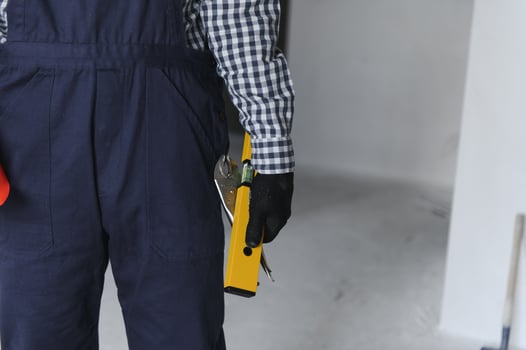 Builder handyman with construction tools. House renovation background. photo