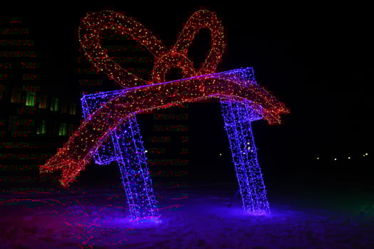 Christmas neon gift figure in blue and red color. Outdoor Decorations photo