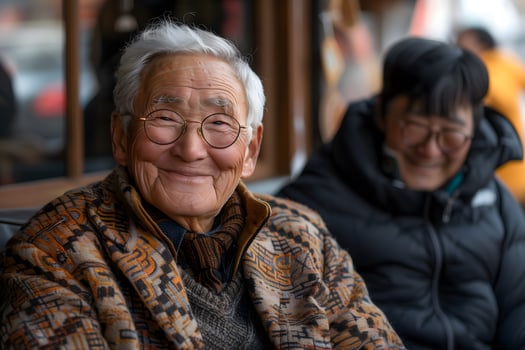 Senior Asian man smiling with family in a cozy setting photo