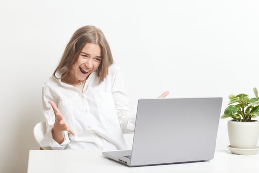 happy girl with laptop rejoices at successful work while working in the office, success at work photo