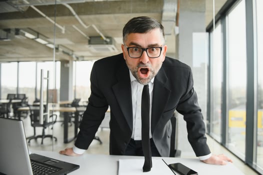 Angry businessman with document shouting at somebody photo