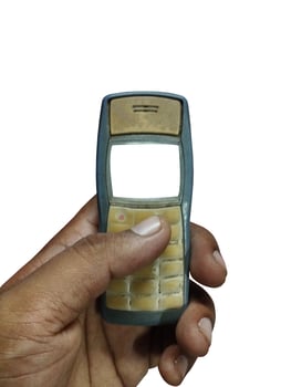 Vintage Mobile Phone Held in a Hand photo