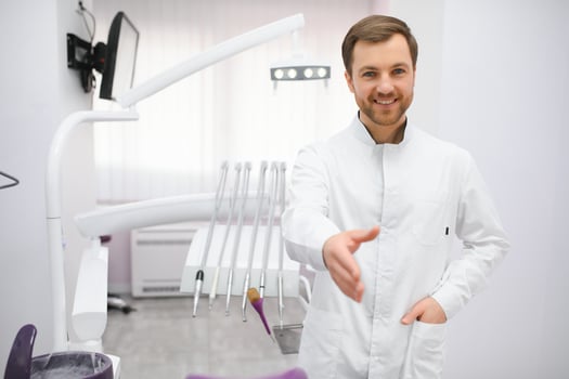 Young male dentist in clinic photo