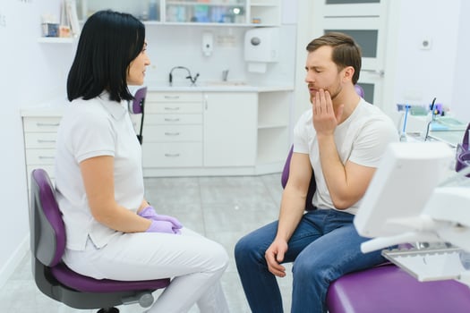 Dental care concept. Handsome young guy at the dentist's office. photo